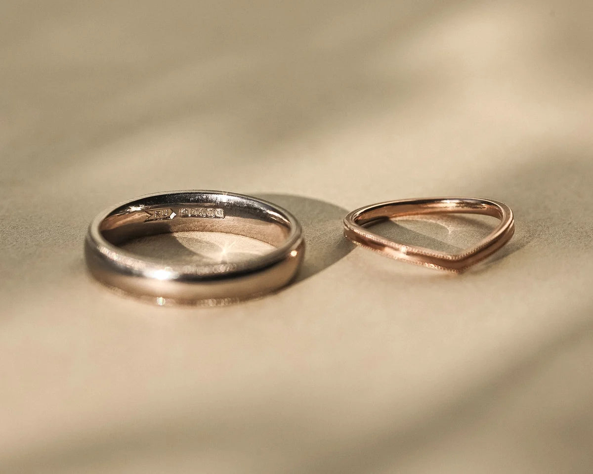 18ct white gold milled edge wedding ring paired with rose gold wishbone band