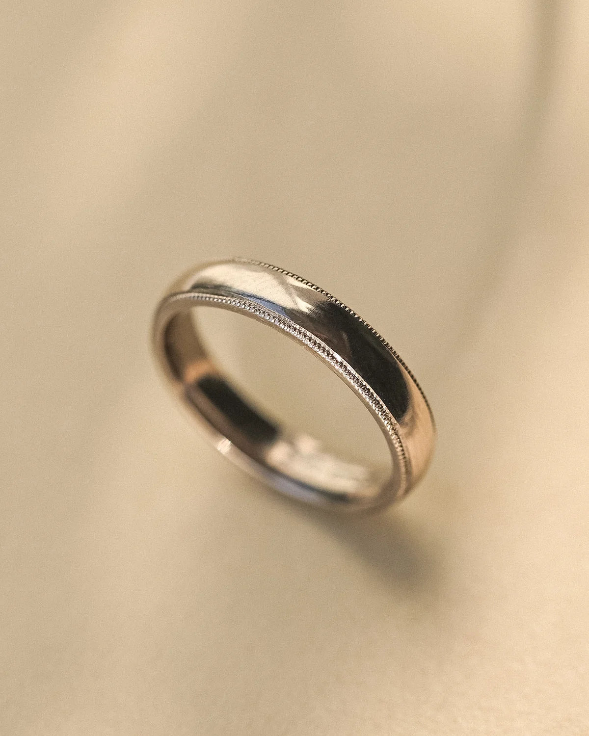 Minimal 18ct white gold wedding band with milled edge finish