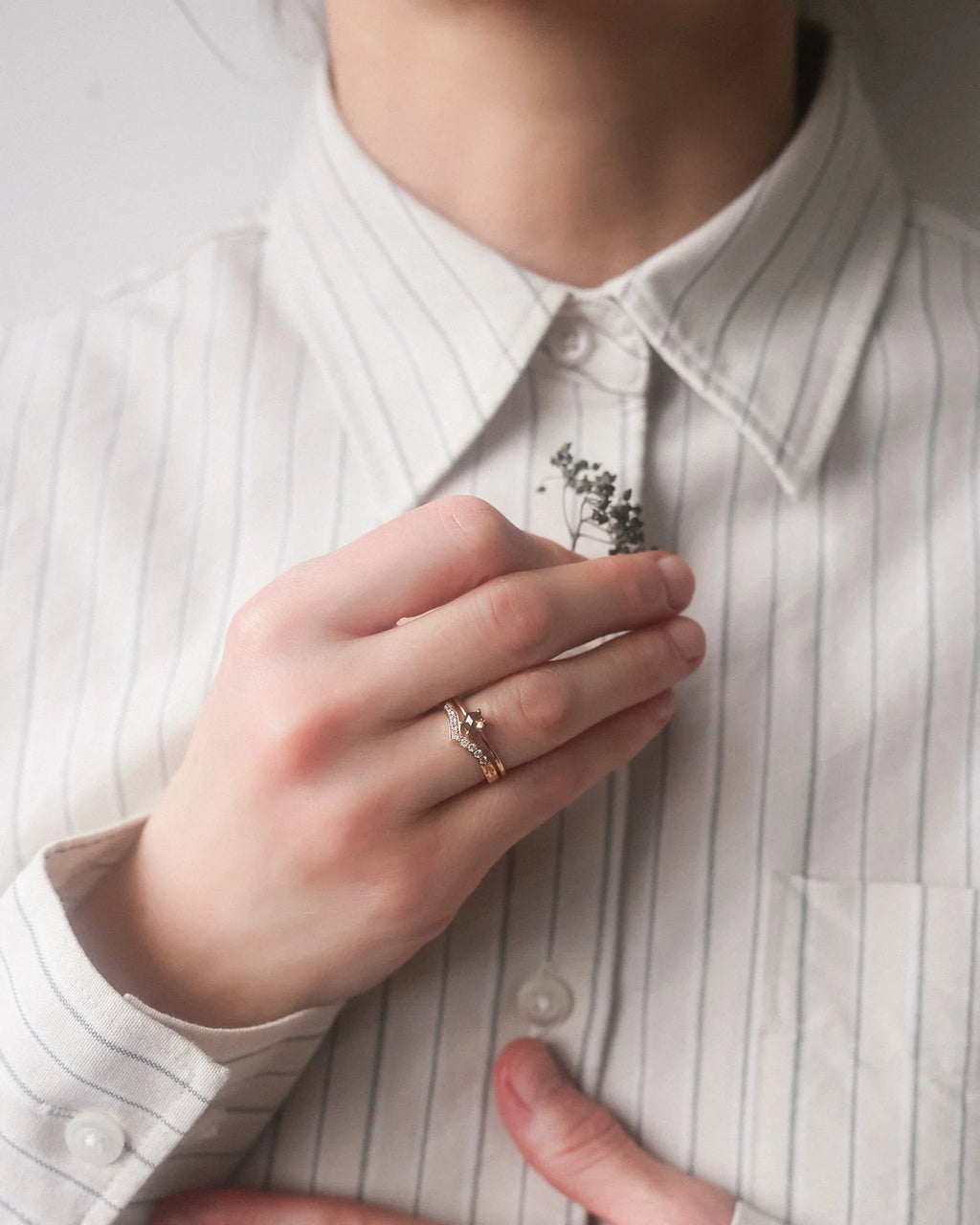 hexagonal diamond ring worn on hand rose gold band