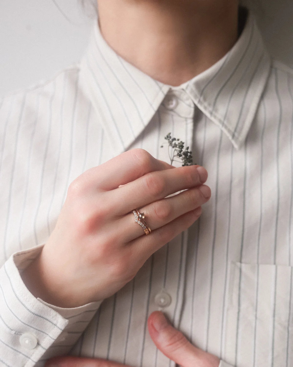 hexagonal diamond ring worn on hand rose gold band
