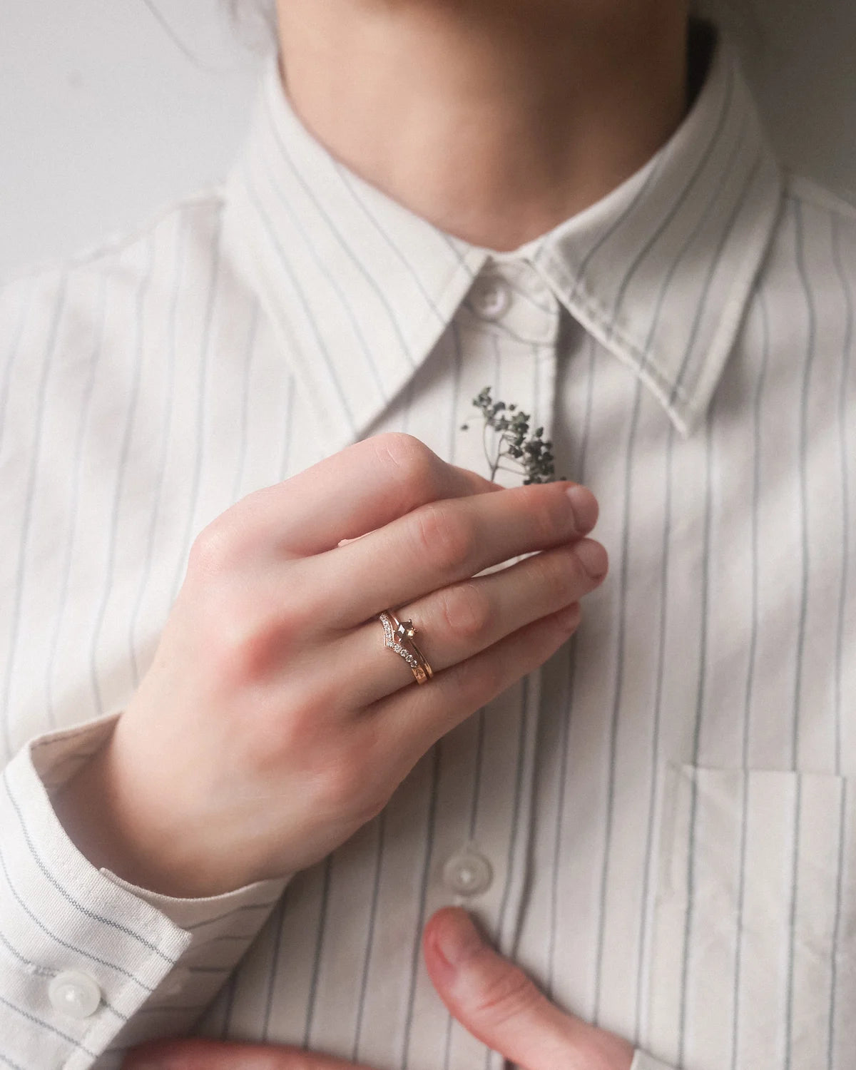 rose gold wishbone ring worn with engagement ring diamond band