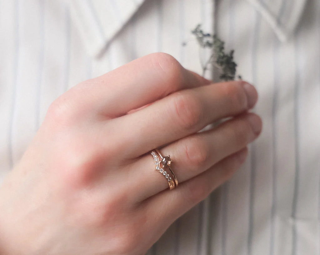 hexagonal diamond ring worn on hand rose gold band
