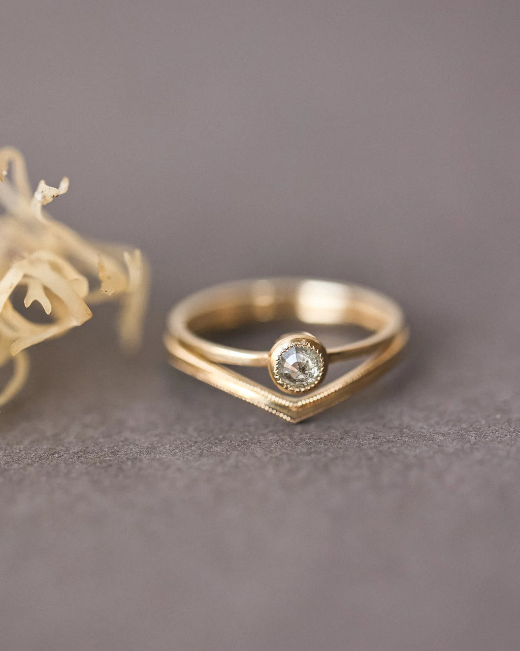 Yellow-grey rose-cut diamond ring paired with curved wishbone wedding band