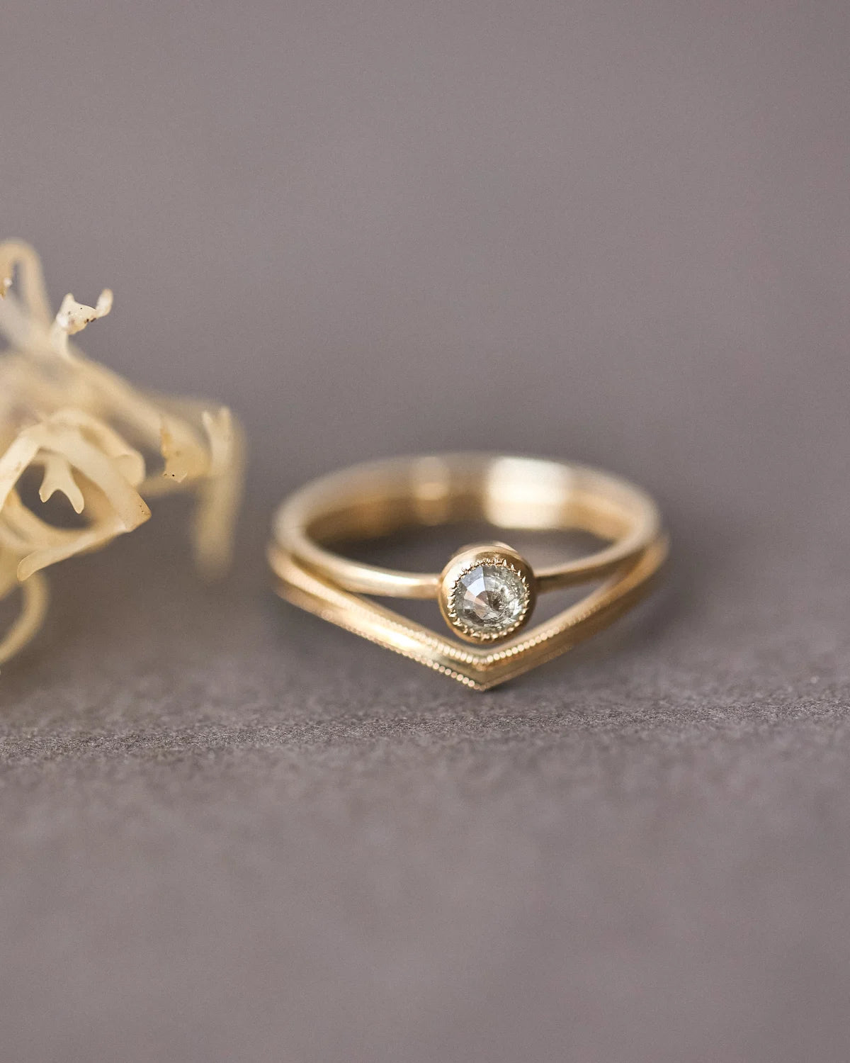 Yellow-grey rose-cut diamond ring paired with curved wishbone wedding band