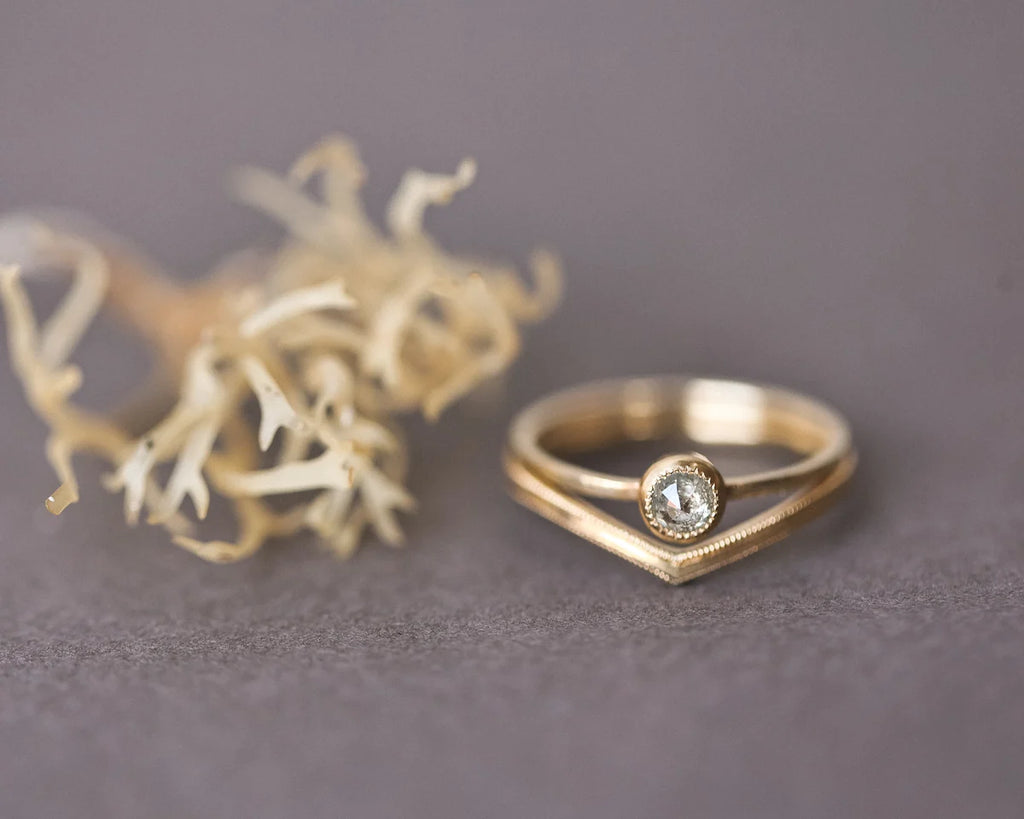 Yellow-grey rose-cut diamond ring paired with curved wishbone wedding band
