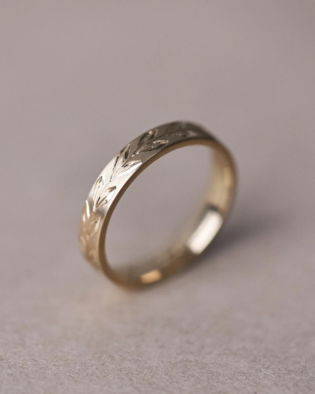Side view of 9ct yellow gold olive leaf engraved wedding band