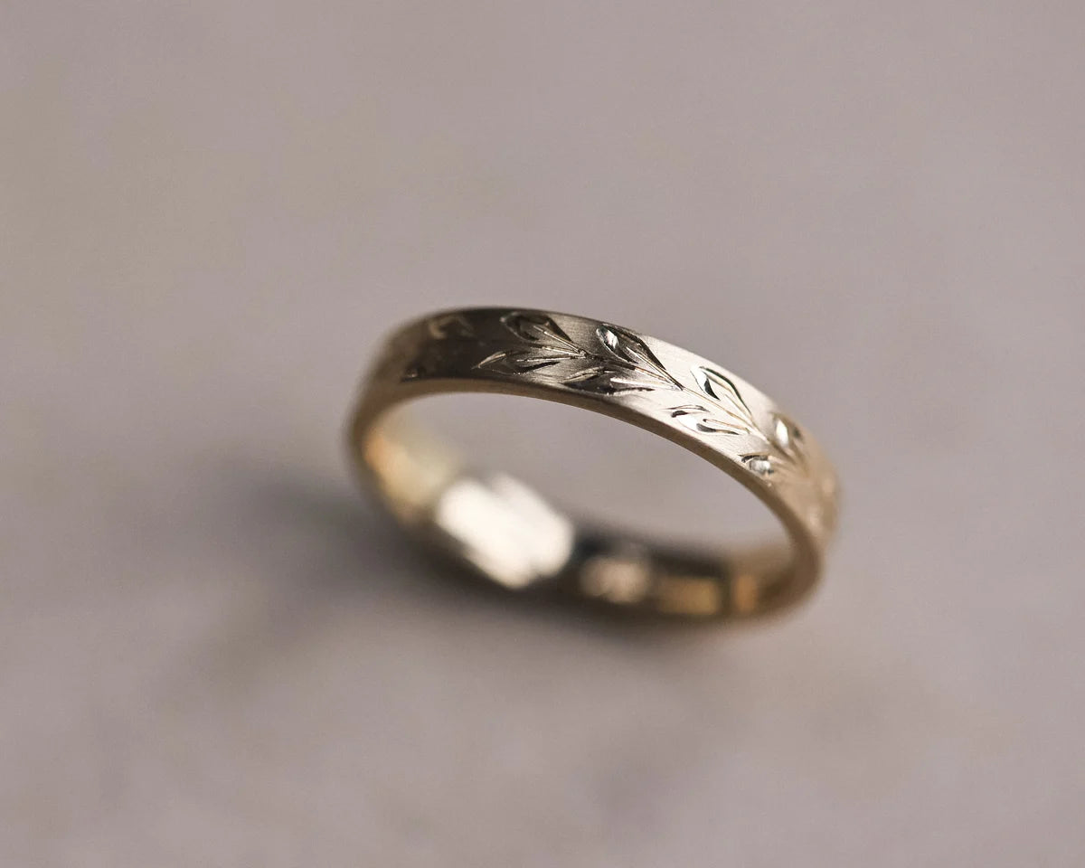 Handmade olive leaf engraved flat court ring in matte yellow gold