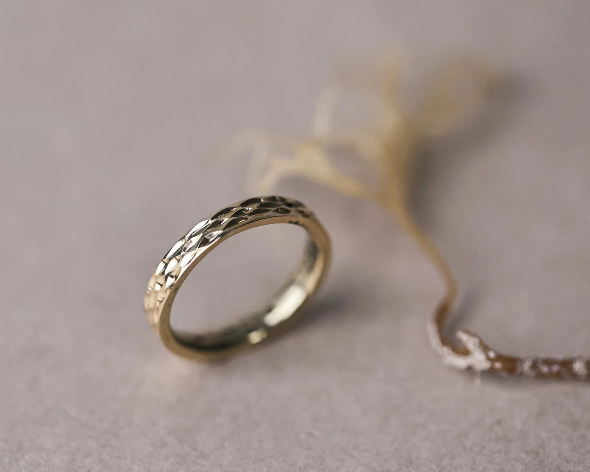 gold band engraved texture catching light detail