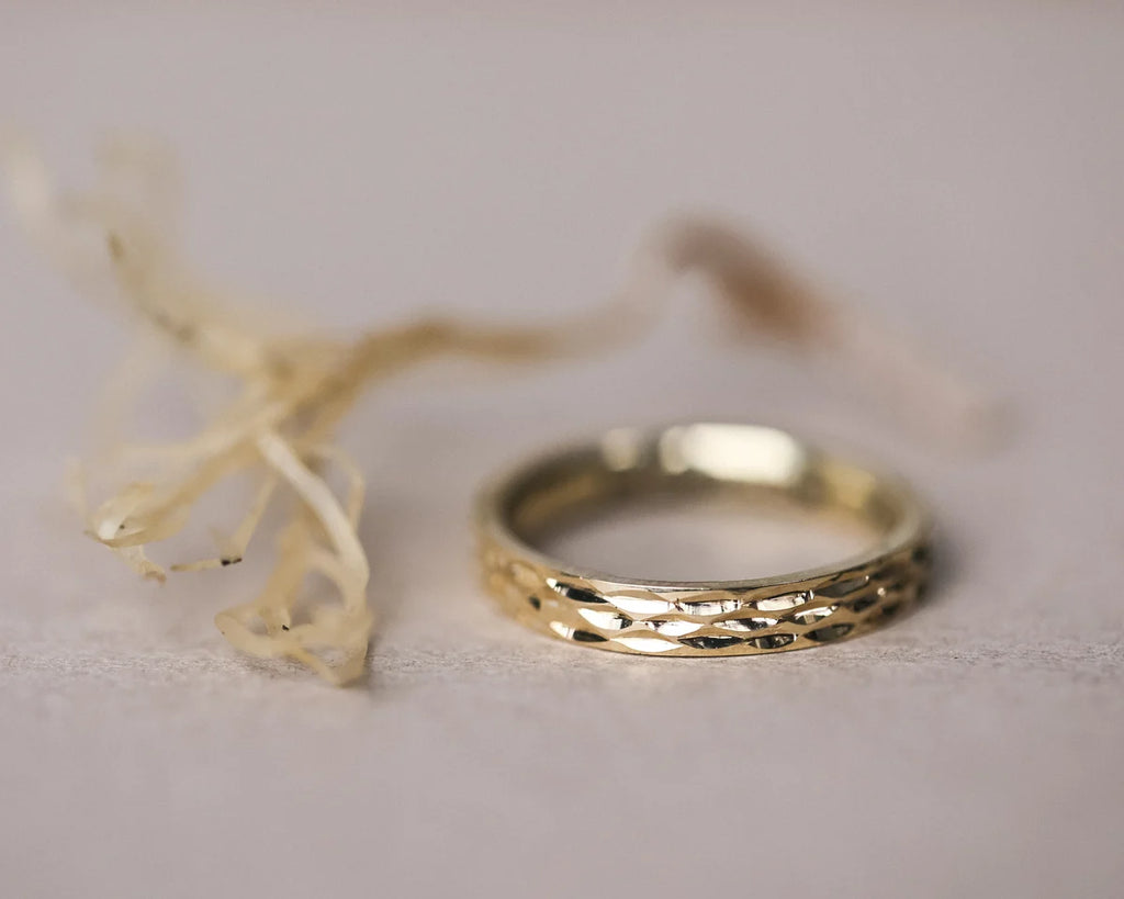 natural light on textured gold wedding ring close up