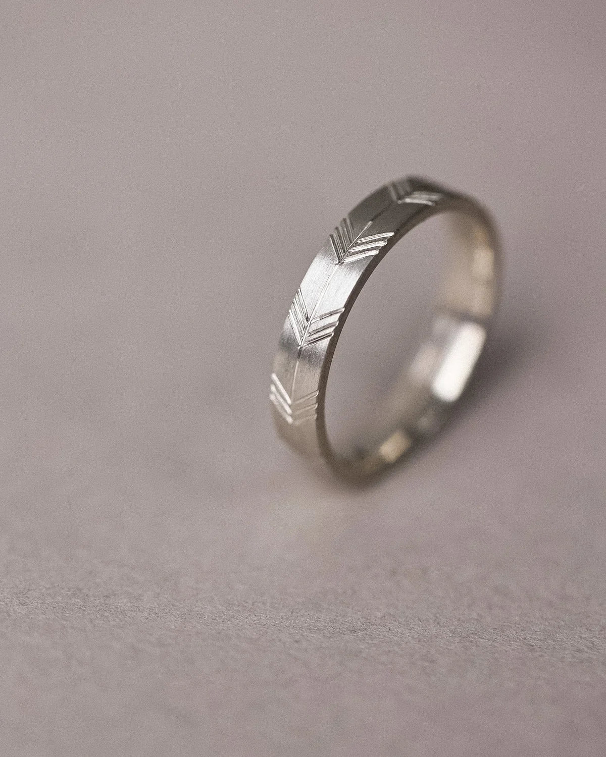 geometric arrow engraving design white gold band
