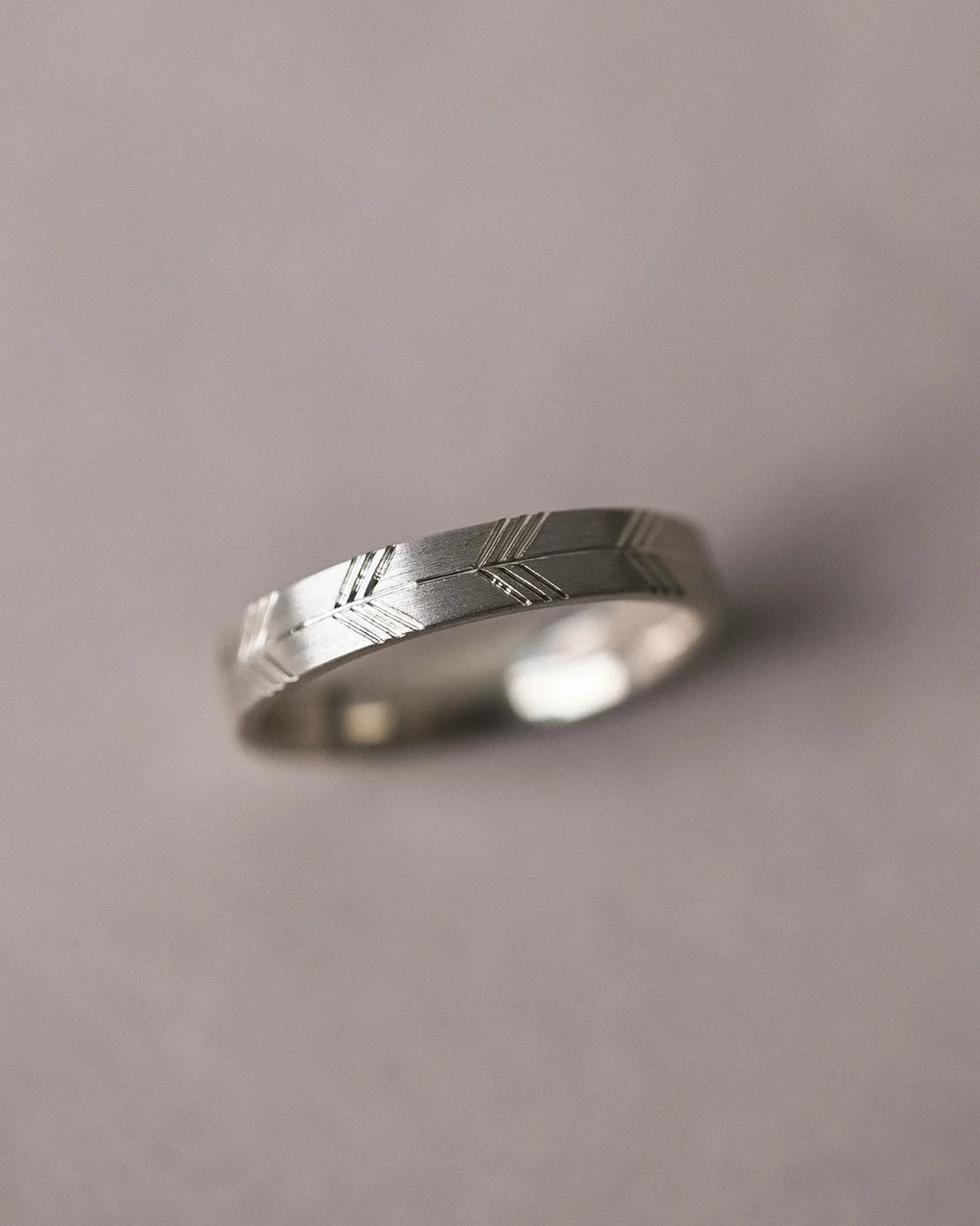 close up japanese arrows engraving on 4mm white gold ring