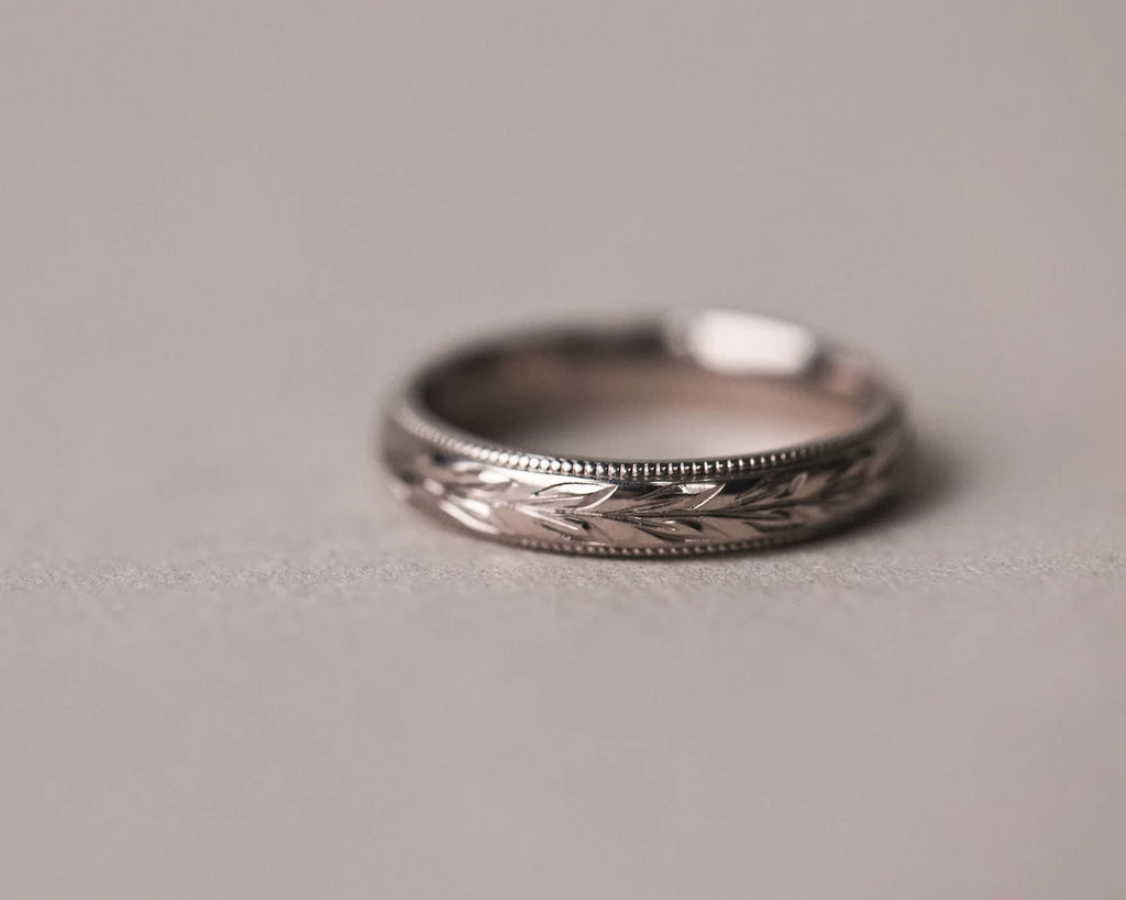 Minimal 18ct white gold wedding band with engraved olive leaf design