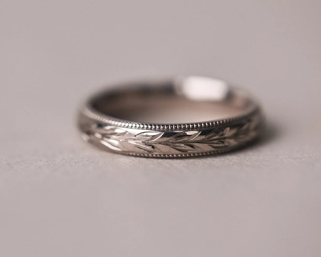 Front view of handmade white gold wedding ring with olive leaf motif