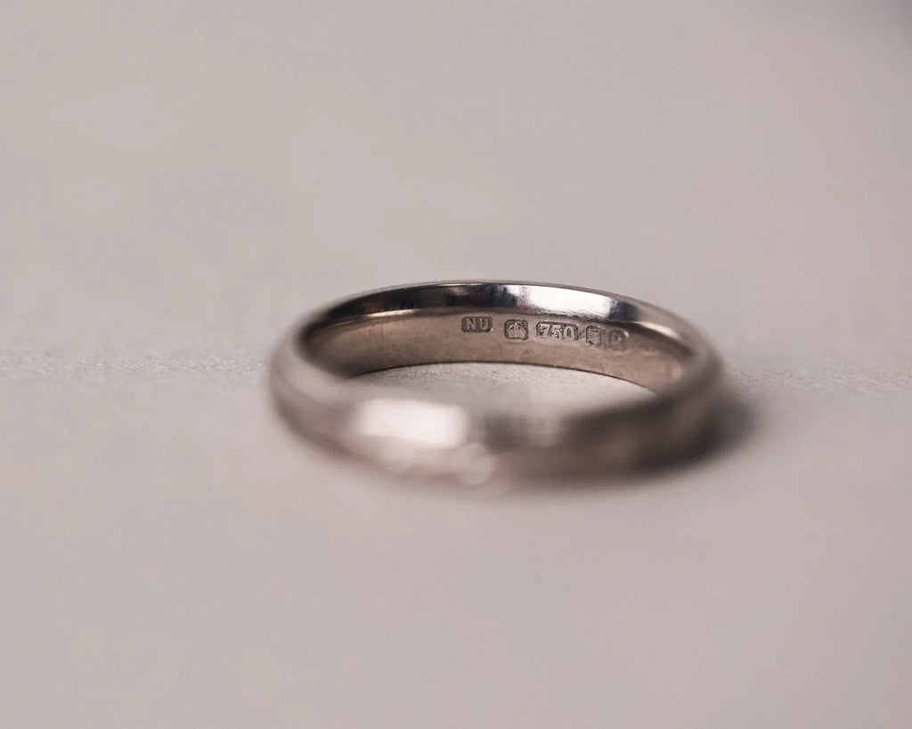 Low front view of olive leaf engraved wedding ring in 18ct white gold