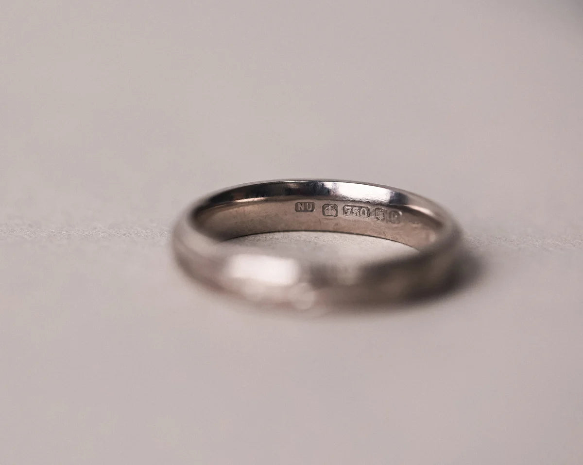 Low front view of olive leaf engraved wedding ring in 18ct white gold