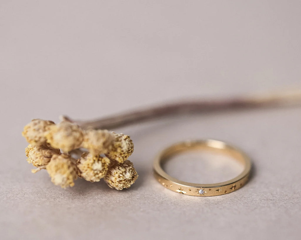 Low front view of star set diamond eternity ring in yellow gold