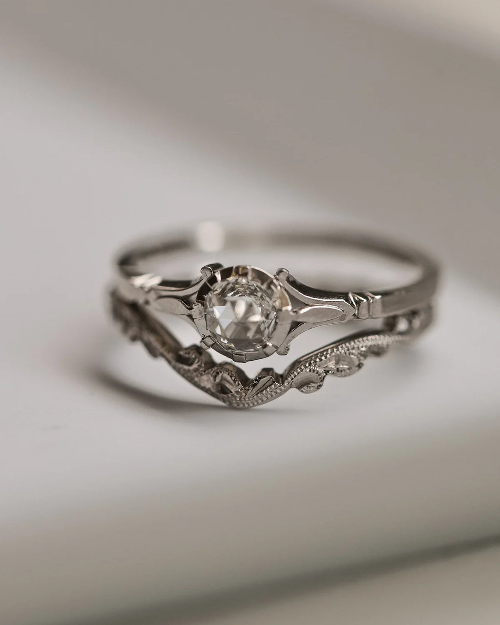 Silver ring with a diamond on a light background
