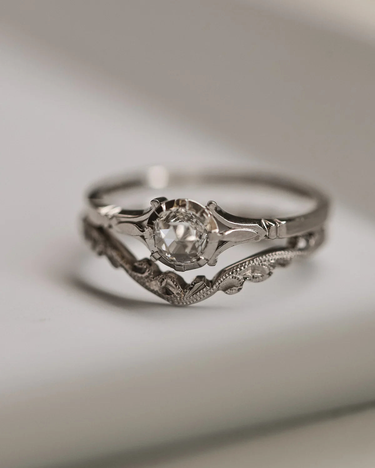 Silver ring with a diamond on a light background
