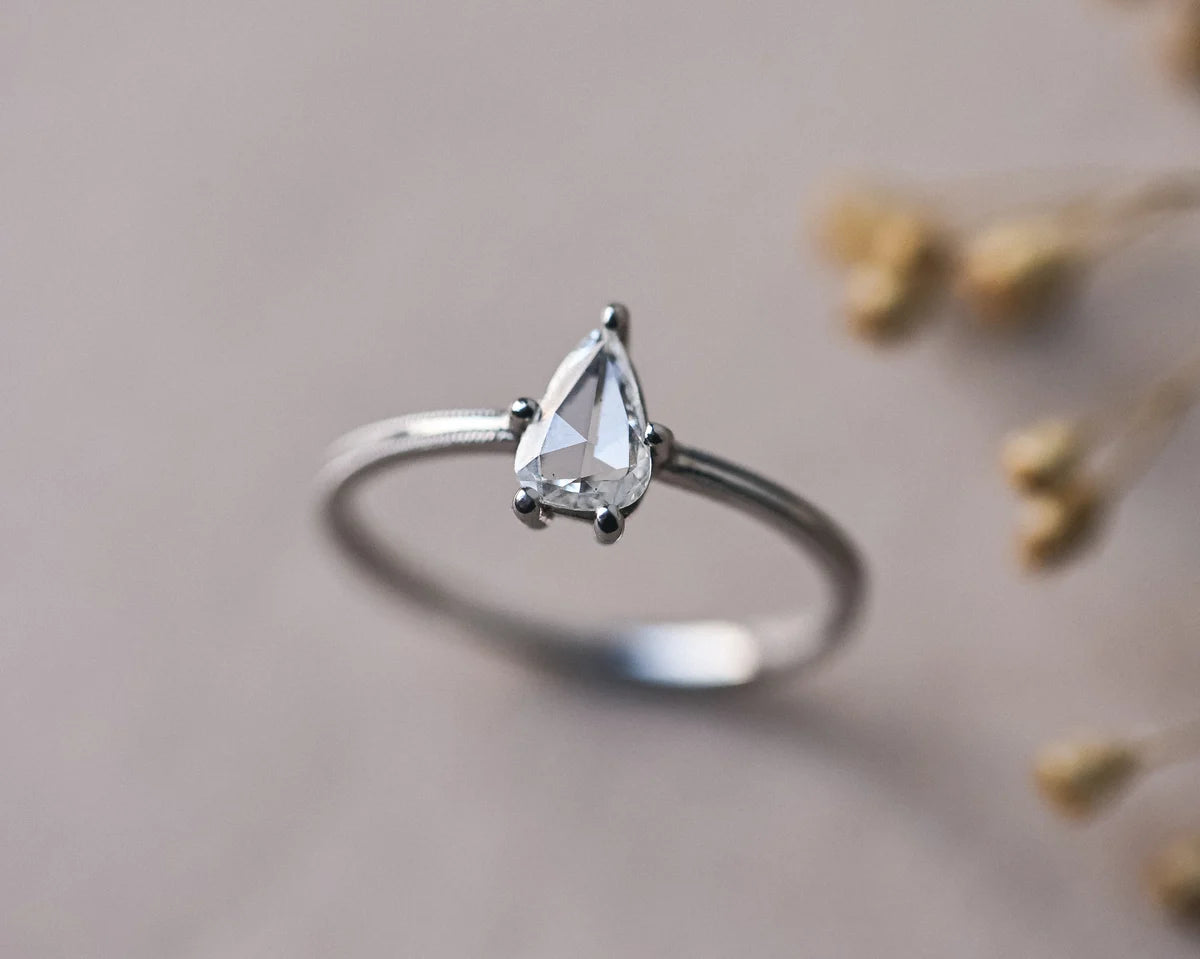 One-of-a-kind platinum ring with pear cut white diamond