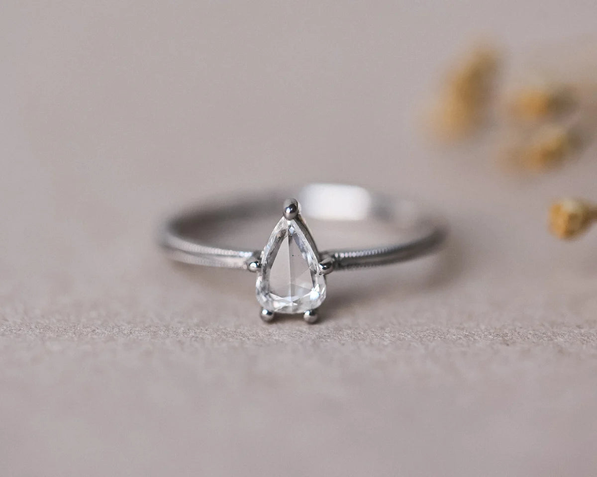 One-of-a-kind pear cut diamond ring in platinum with milled edge band