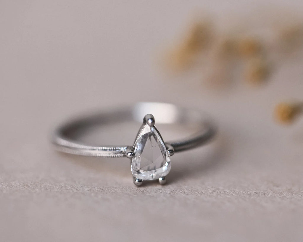 Close-up of pear cut white diamond ring in platinum