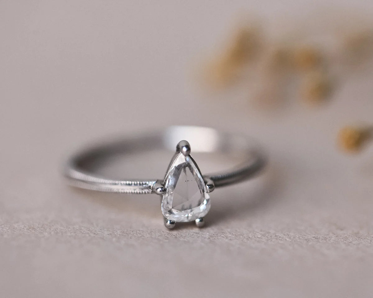 Close-up of pear cut white diamond ring in platinum