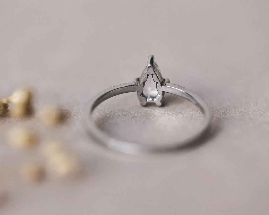 Angled view of handmade platinum pear diamond ring