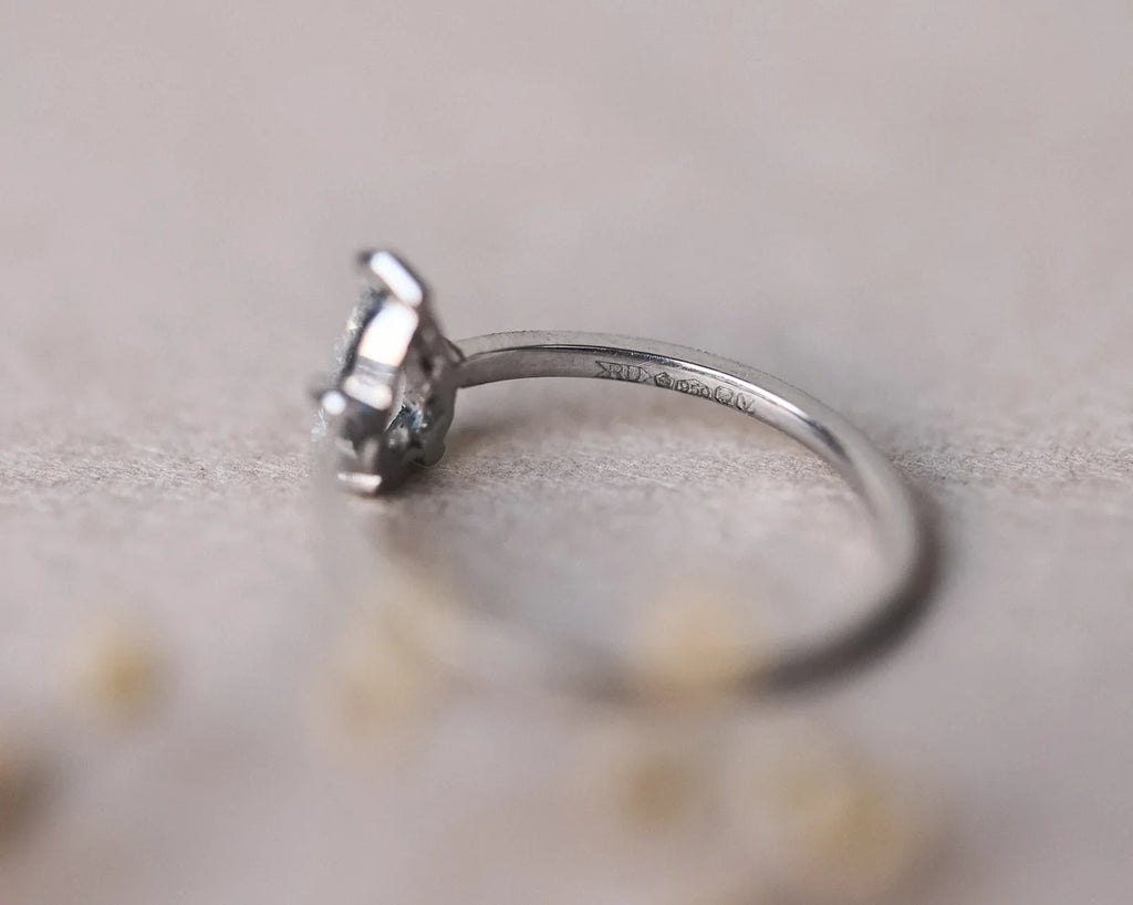 Side profile of pear cut diamond ring with slim platinum band