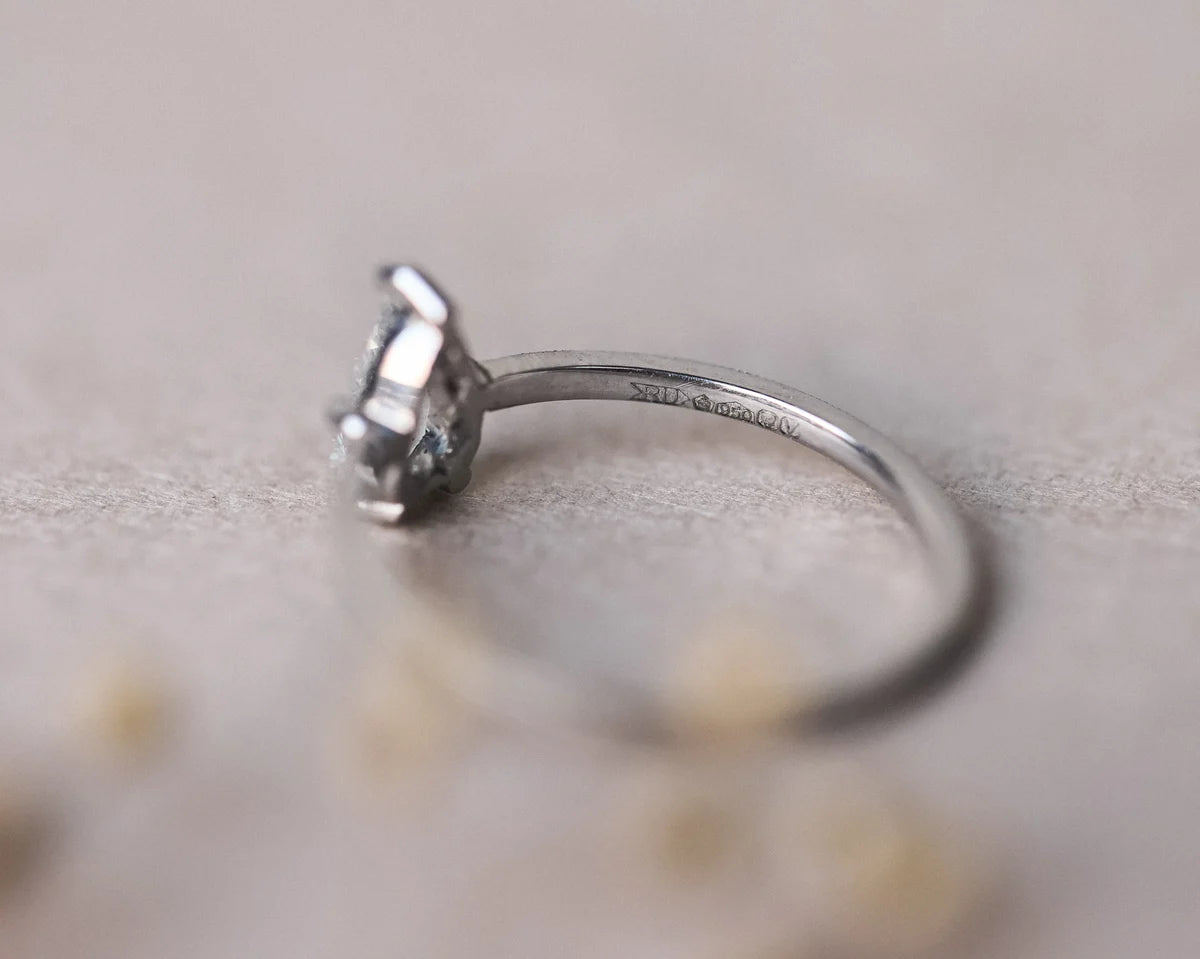 Side profile of pear cut diamond ring with slim platinum band