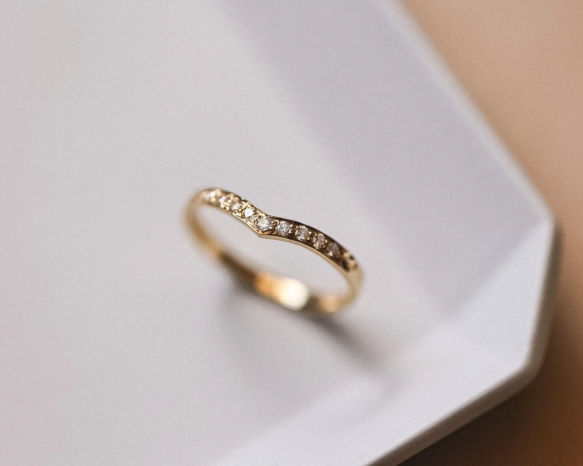 Side view of diamond wishbone semi-eternity ring in yellow gold