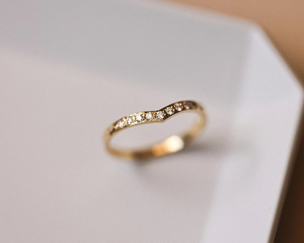 Angled view of 18ct yellow gold diamond wishbone semi-eternity ring
