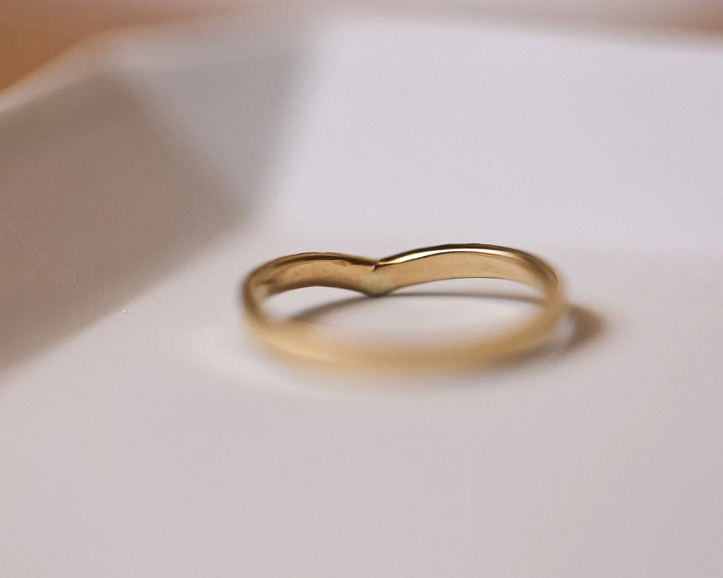 Low profile view of yellow gold wishbone wedding ring