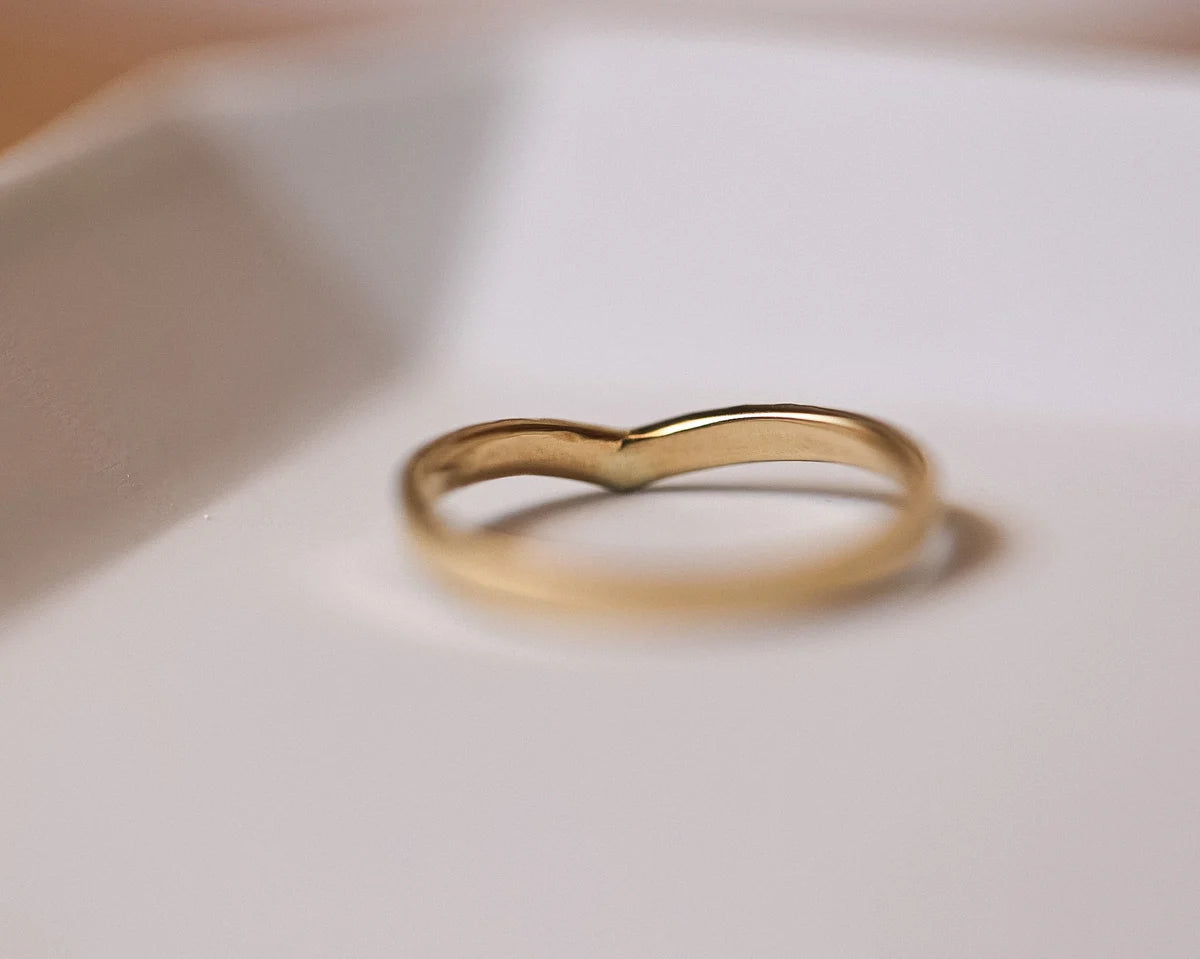 Low profile view of yellow gold wishbone wedding ring