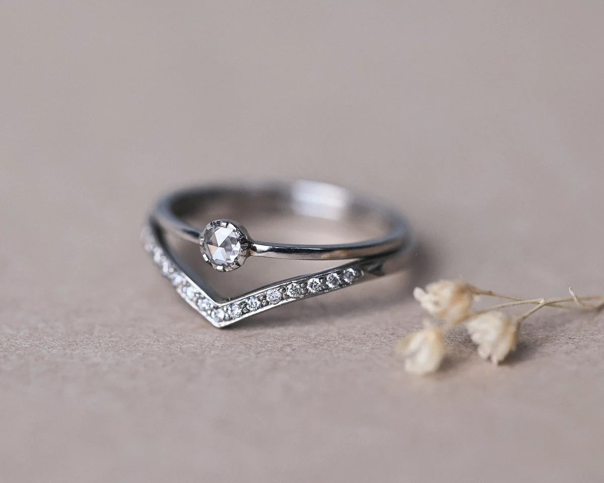 Platinum rose-cut diamond ring paired with pavé wishbone wedding band