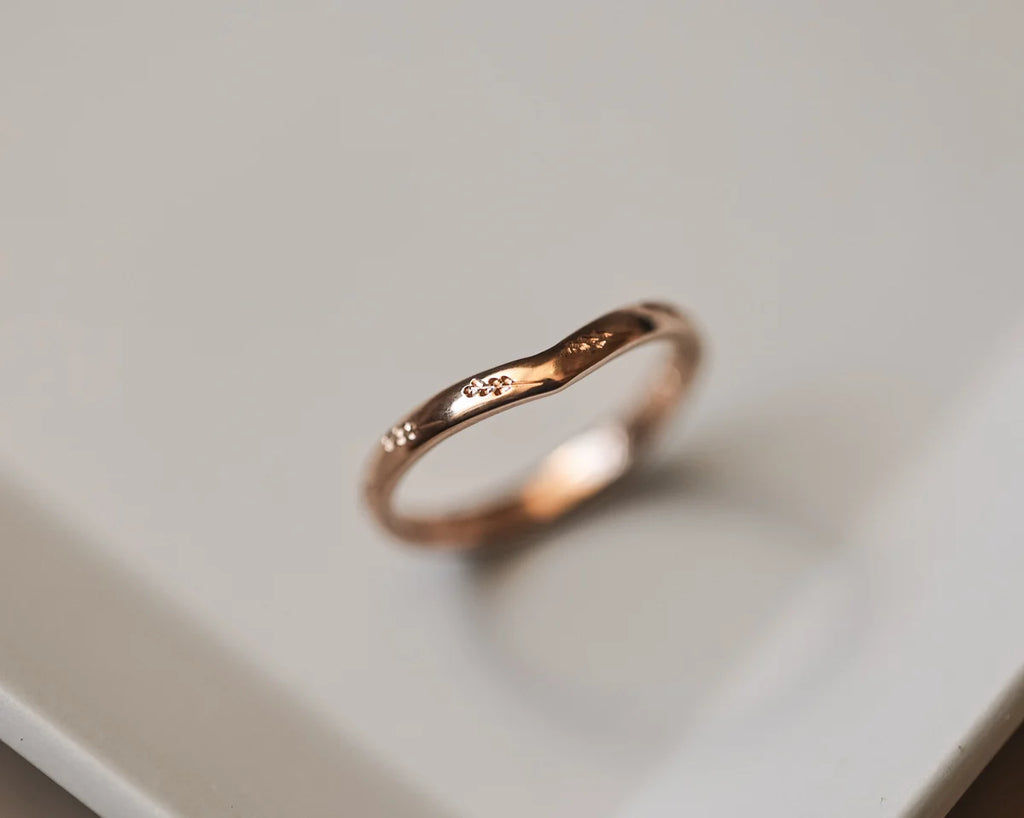 Side view of 2mm rose gold wishbone ring with barleycorn engraving