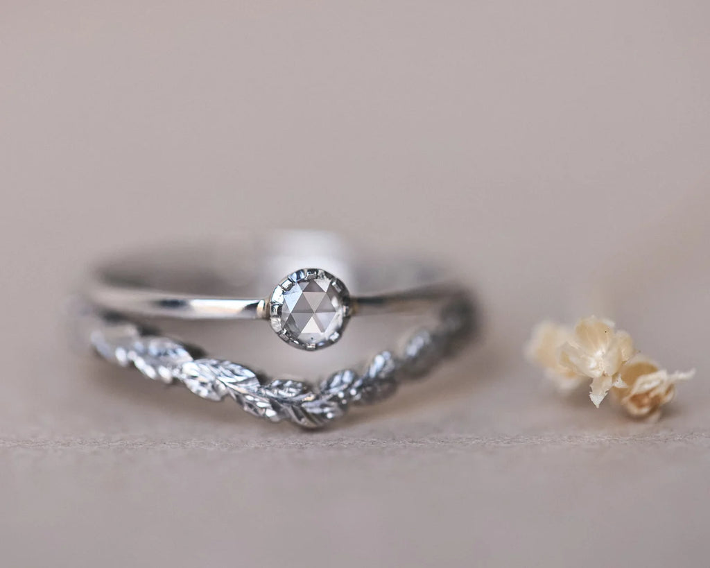 Stacked platinum rose-cut diamond ring and pavé wishbone wedding band