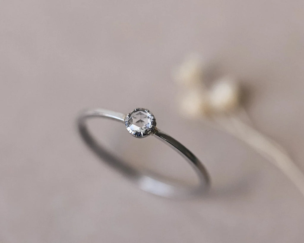 Soft focus view of 3mm rose-cut diamond ring in platinum