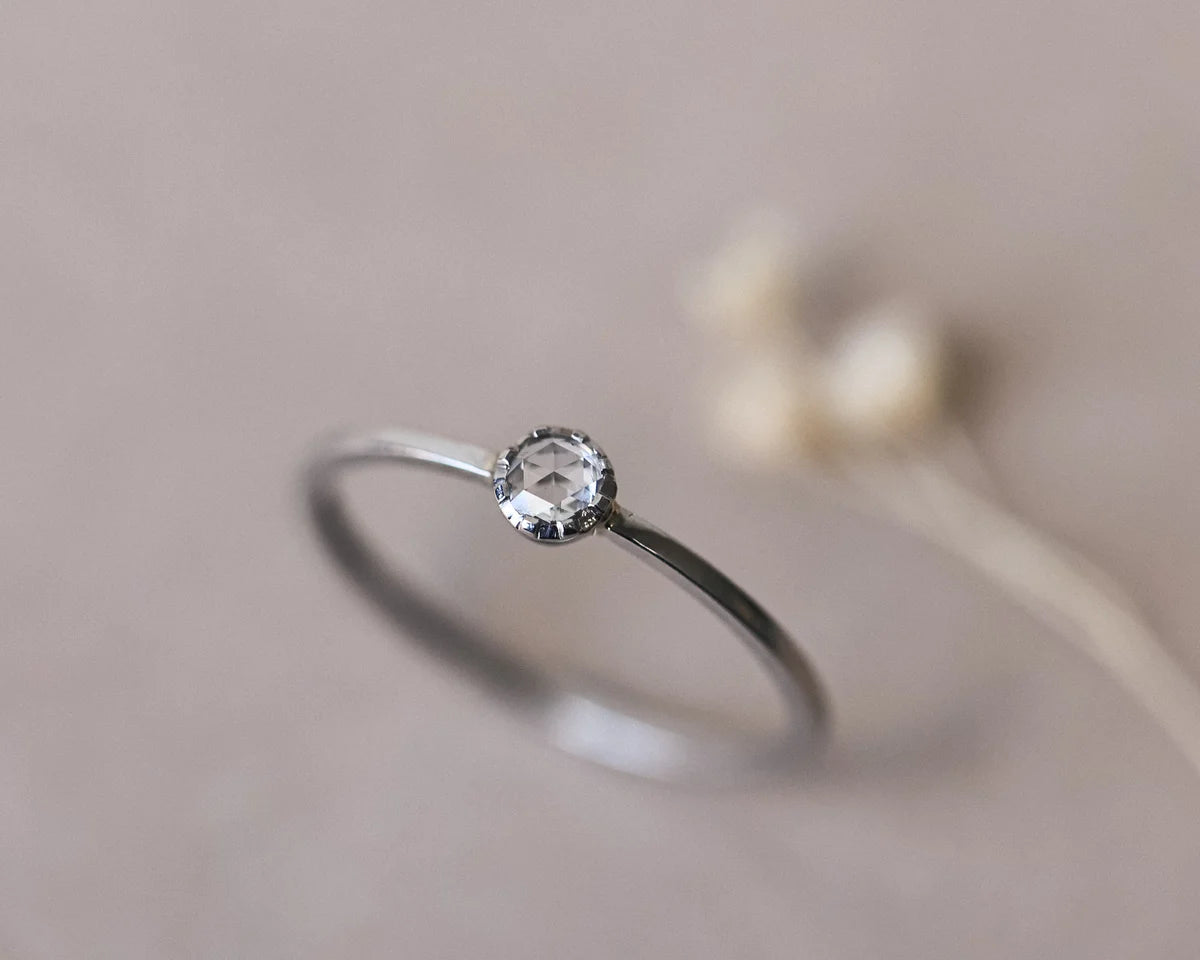 Soft focus view of 3mm rose-cut diamond ring in platinum