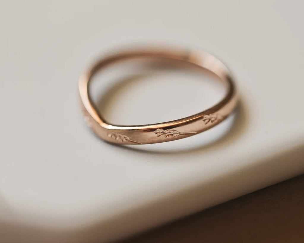 Close-up of 18ct rose gold barleycorn wishbone wedding ring