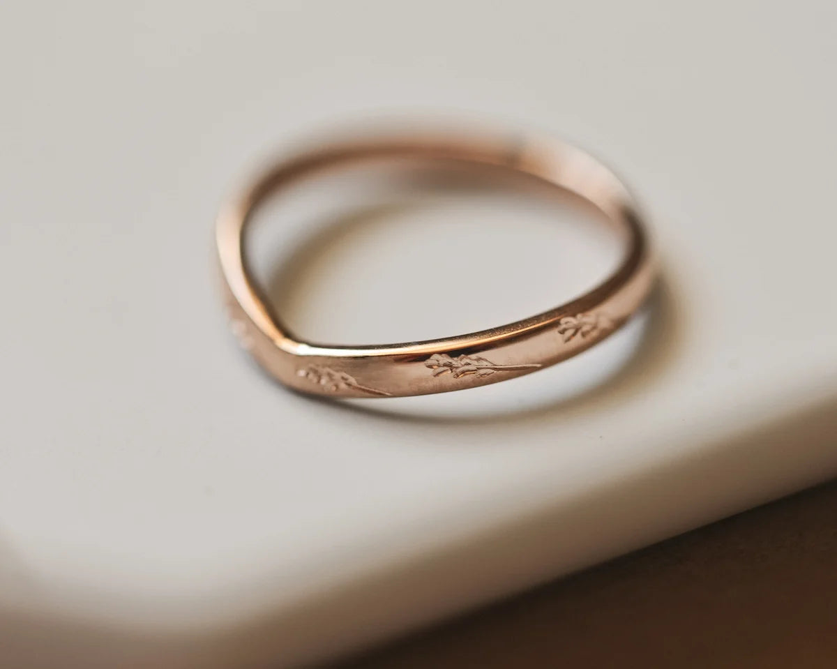 Close-up of 18ct rose gold barleycorn wishbone wedding ring
