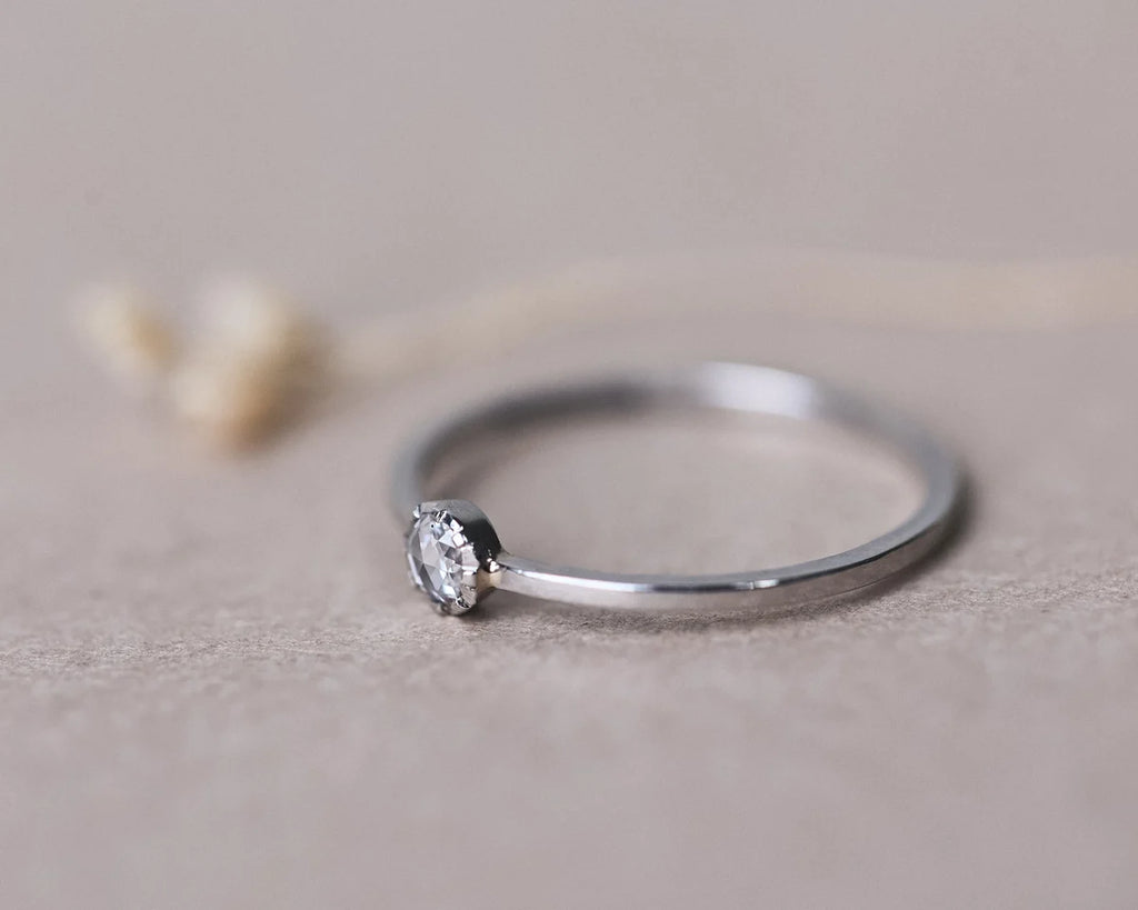 Close-up side view of 3mm rose-cut diamond ring in platinum