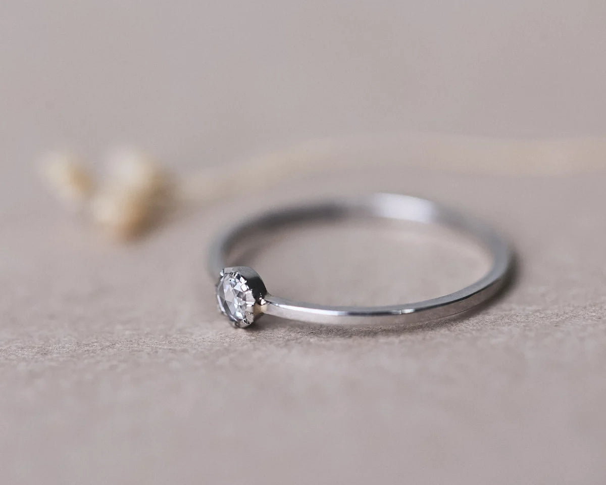 Close-up side view of 3mm rose-cut diamond ring in platinum