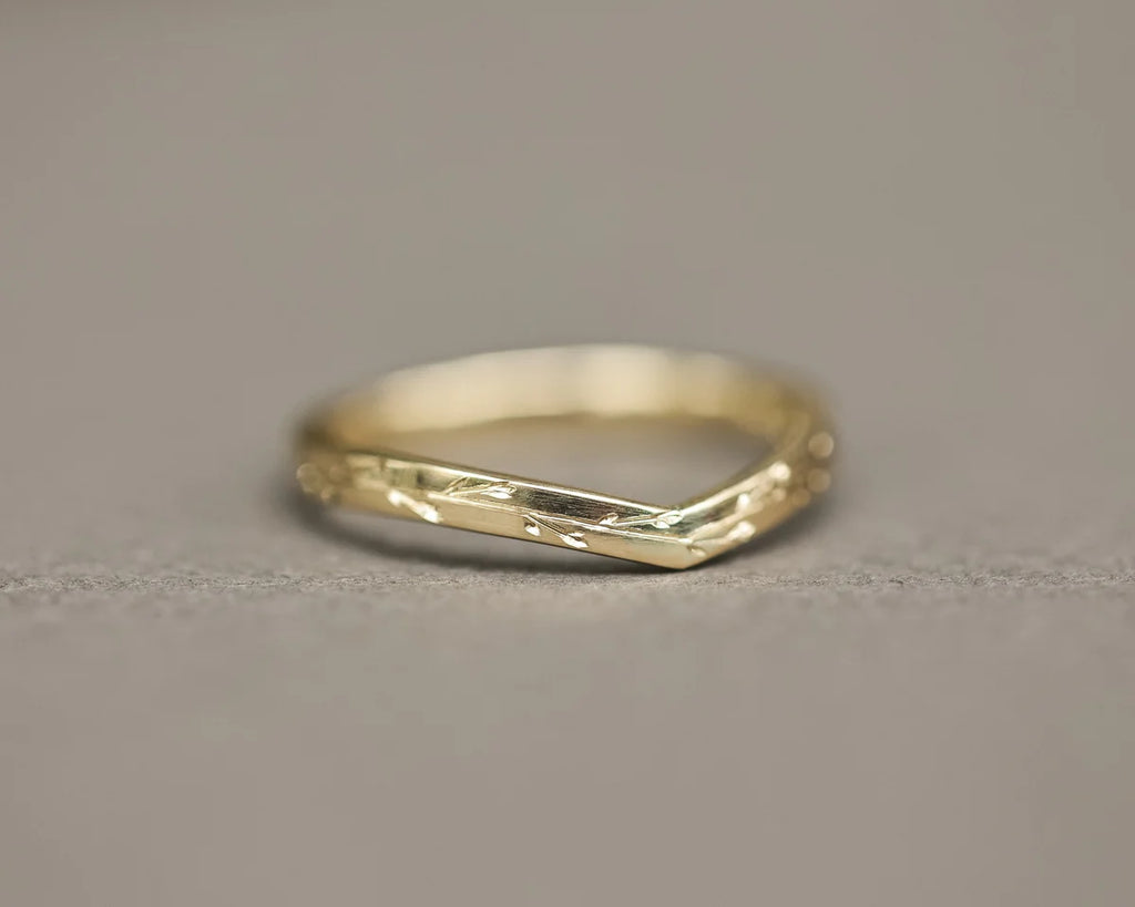 Low front view of handmade pressed flower wishbone ring in yellow gold