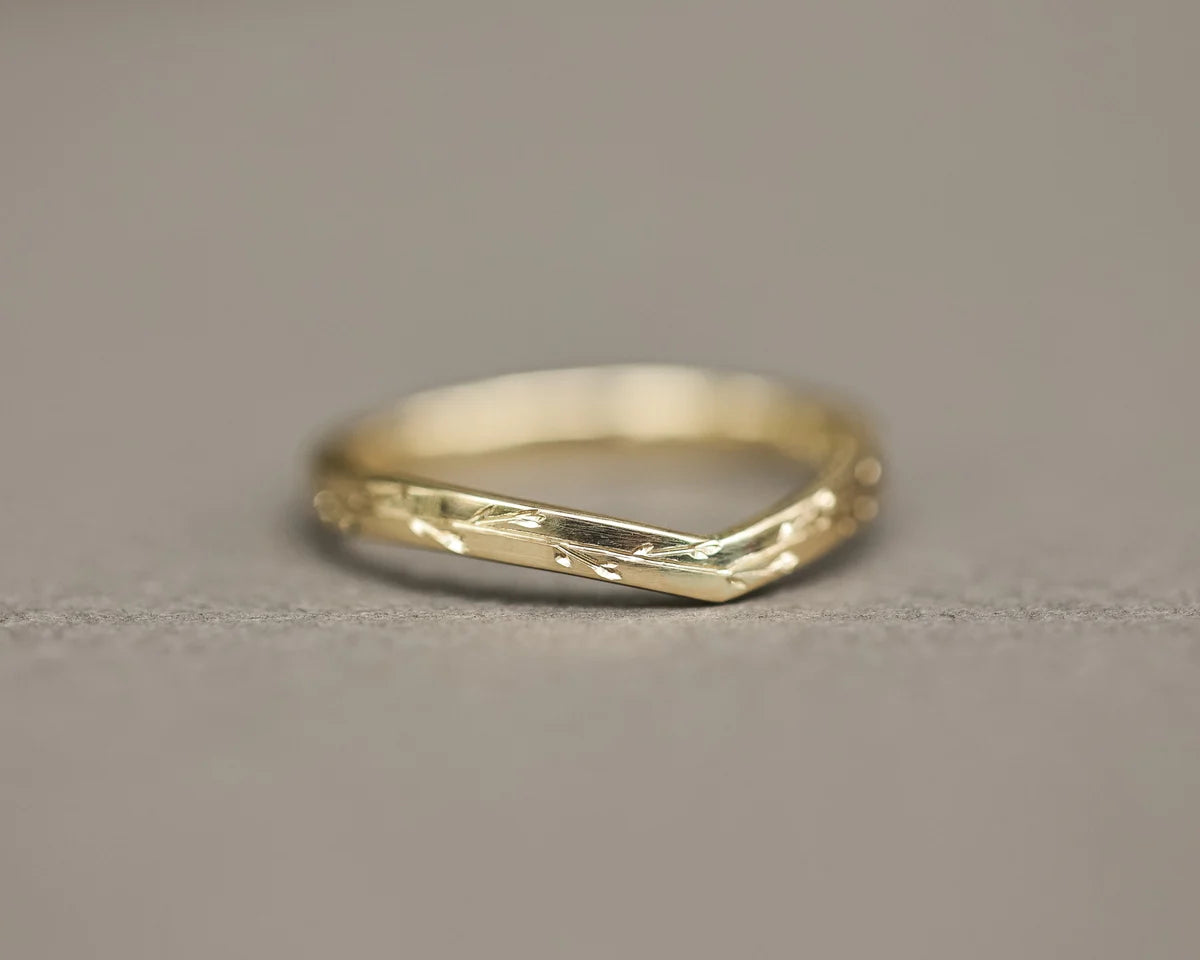 Low front view of handmade pressed flower wishbone ring in yellow gold