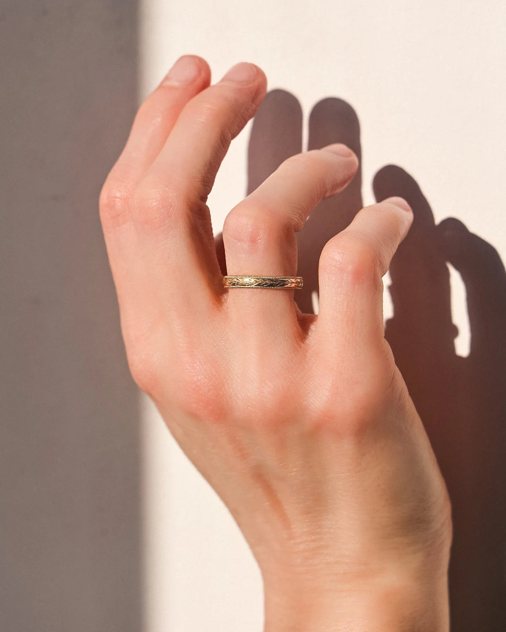 gold wedding ring worn on hand olive engraved band
