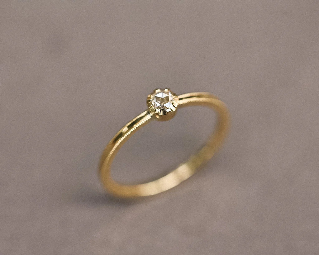Angled view of a 3mm rose-cut diamond ring in 18ct yellow gold