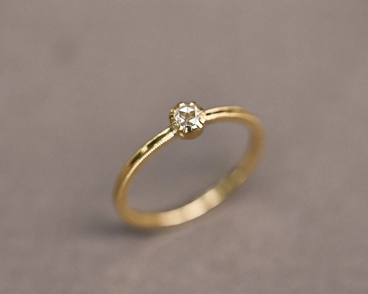 Angled view of a 3mm rose-cut diamond ring in 18ct yellow gold