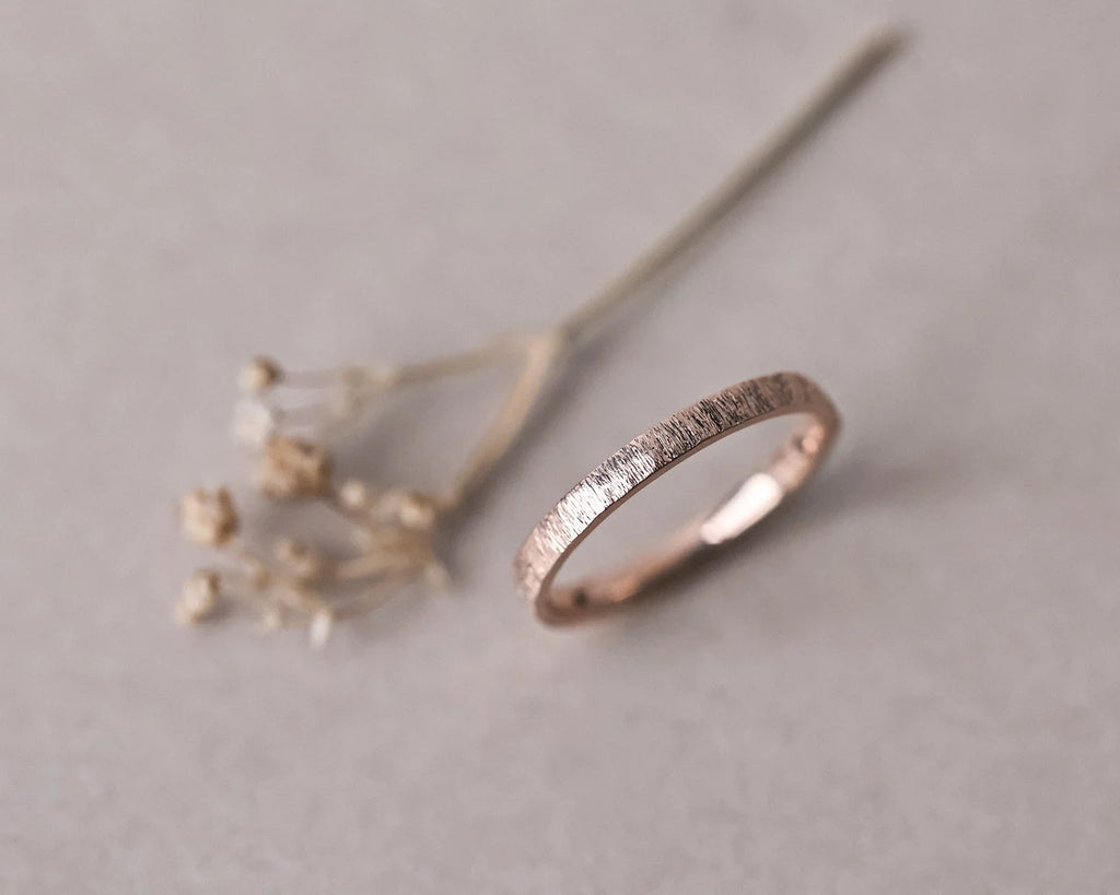 Minimal 18ct rose gold horn texture wedding band with botanical styling