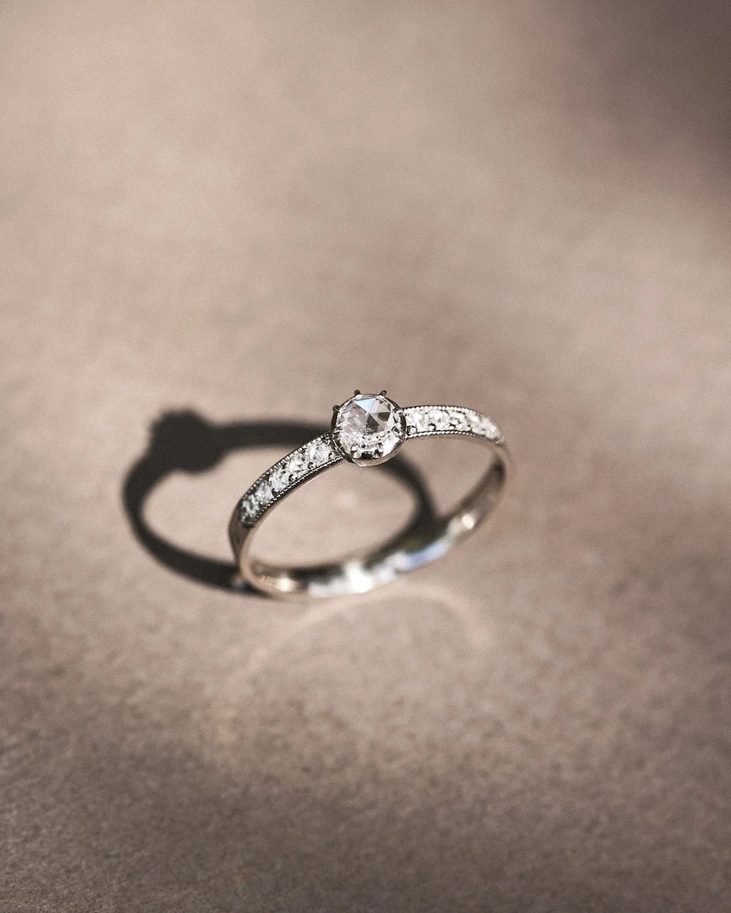  Minimal platinum diamond ring with pavé set band