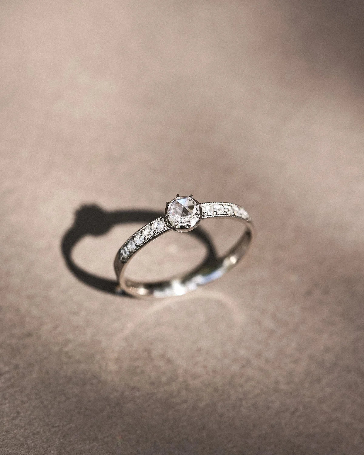  Minimal platinum diamond ring with pavé set band